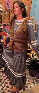 brown faux fur vest over a purple dress